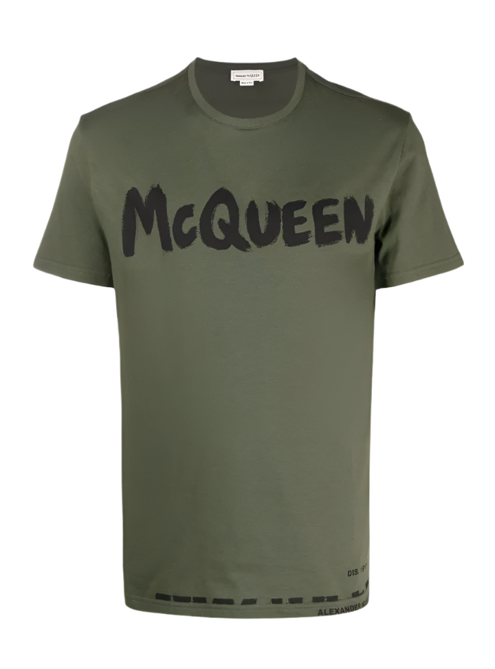 Green t-shirt with 'McQueen' print on a white background