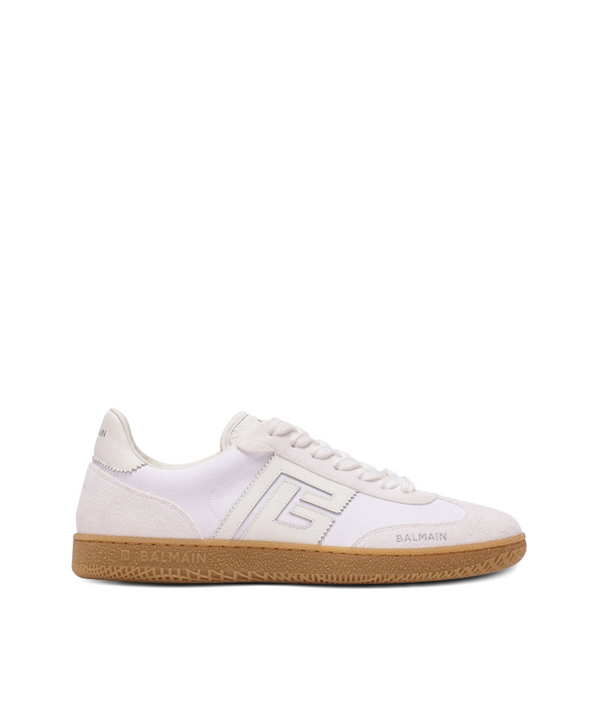 White sneaker with brown sole on a white background