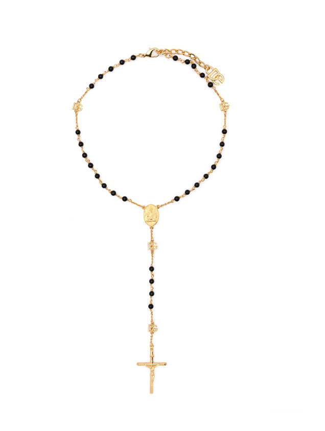 Gold and black beaded necklace with a cross pendant on a white background
